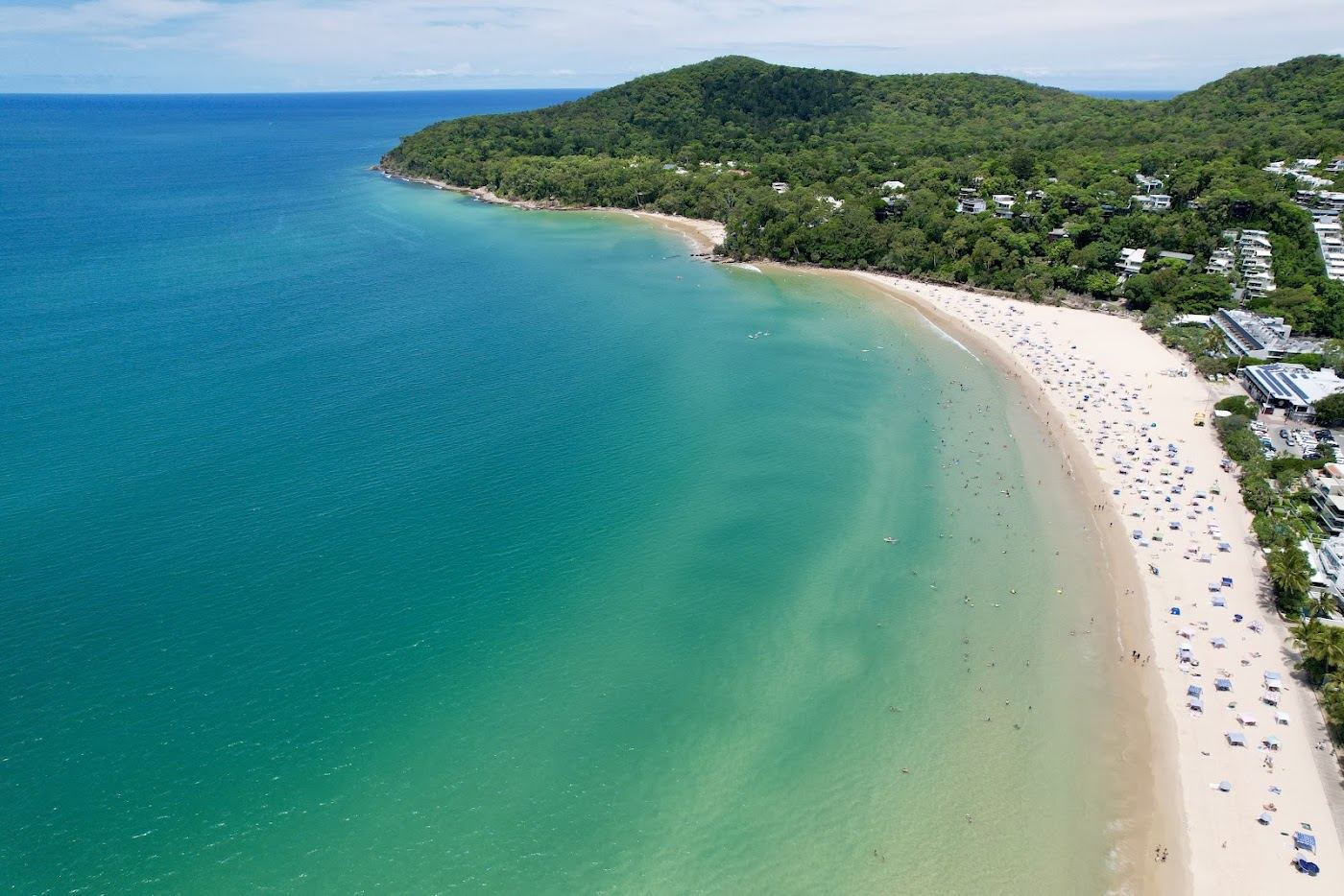 The calm north facing Main Beach at Noosa Heads with golden sand and gentle water by Hastings Street