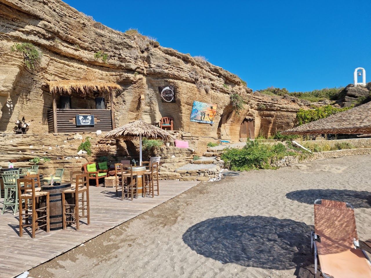Rock ledges and clear water at the cave bar of Oasis Beach at Kallithea in Rhodes