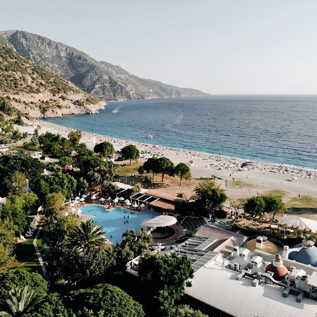 The free public Belcekiz town beach at Oludeniz with clear water beside the blue lagoon