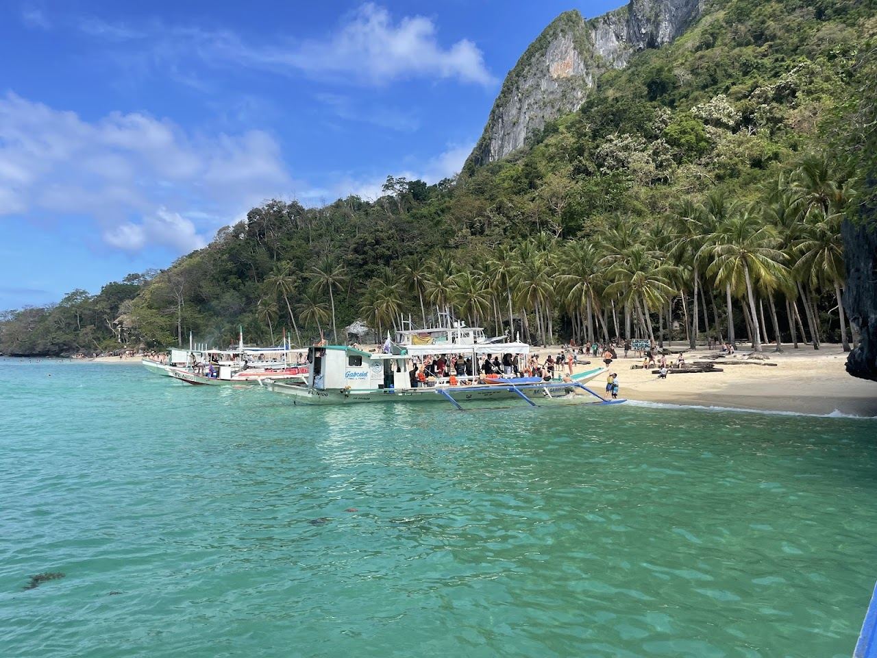 Clear calm water inside the Small Lagoon near El Nido in Palawan, ringed by karst cliffs