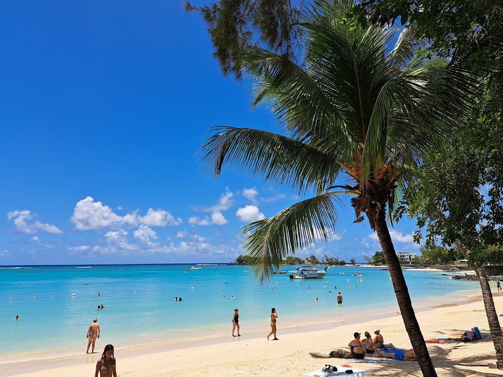 Pereybere beach in Mauritius, a compact bay of soft sand and a clear shallow lagoon close to shops