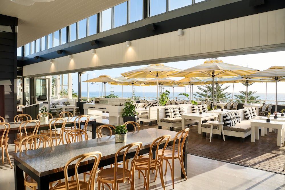 Striped umbrellas and ocean views at The Shorehouse above Swanbourne Beach
