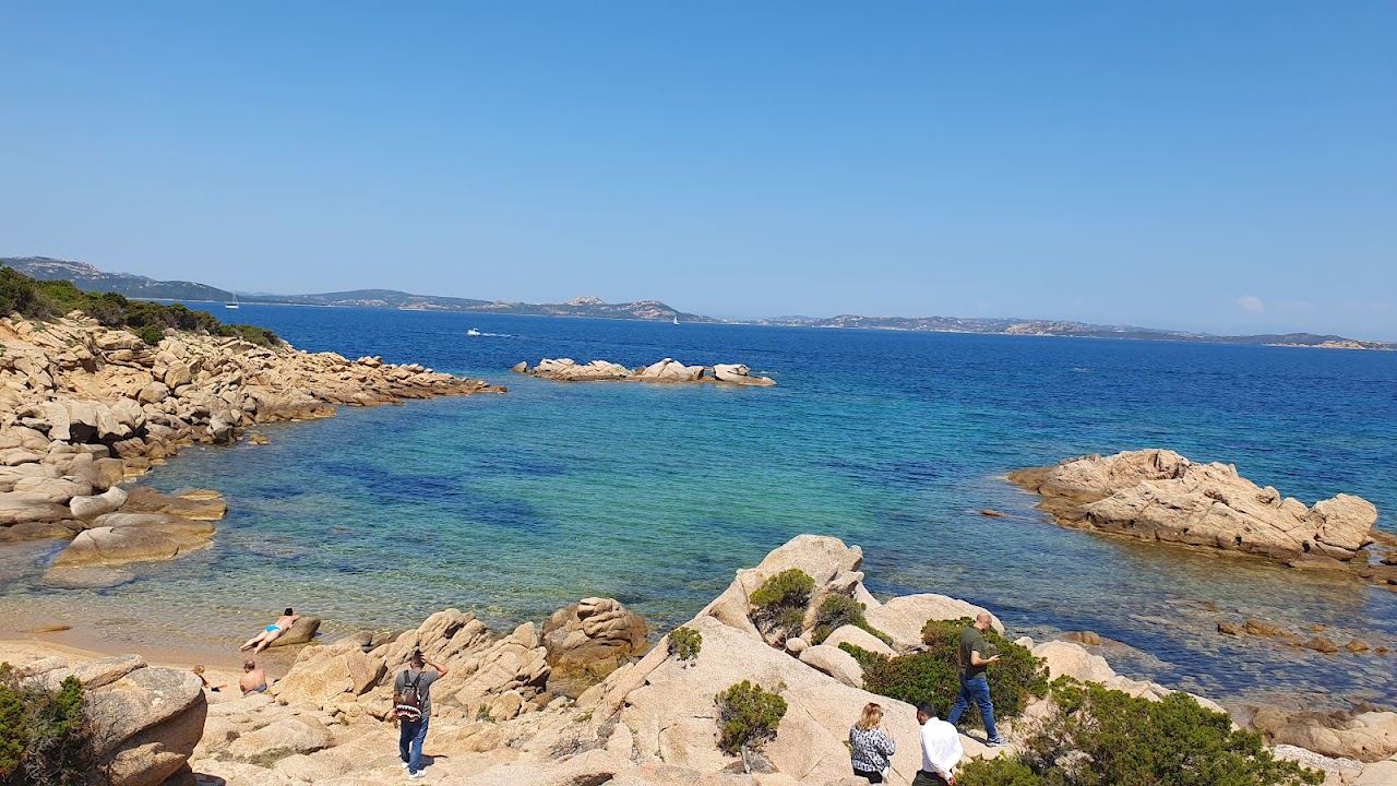 Clear water and granite shoreline at Baja Sardinia near Forte Cappellini