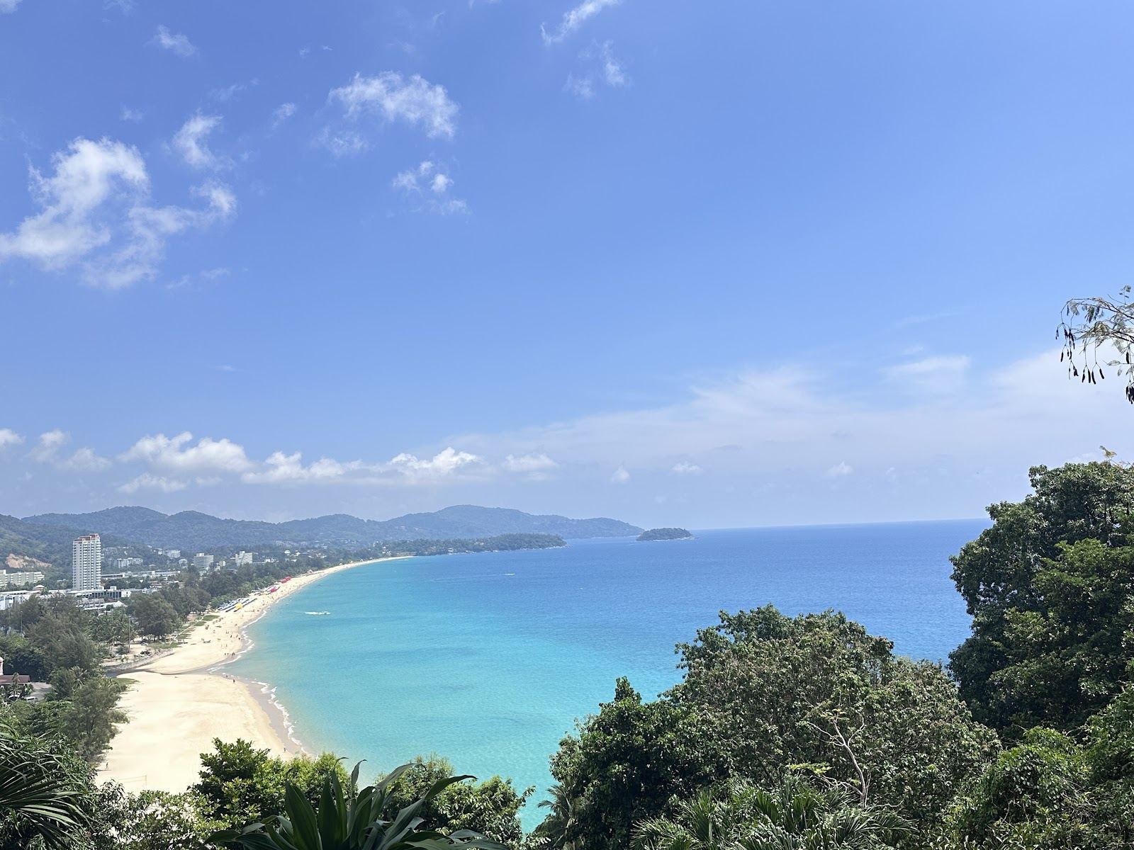 Soft white sand and clear water along the curve of Karon Beach on Phuket's west coast