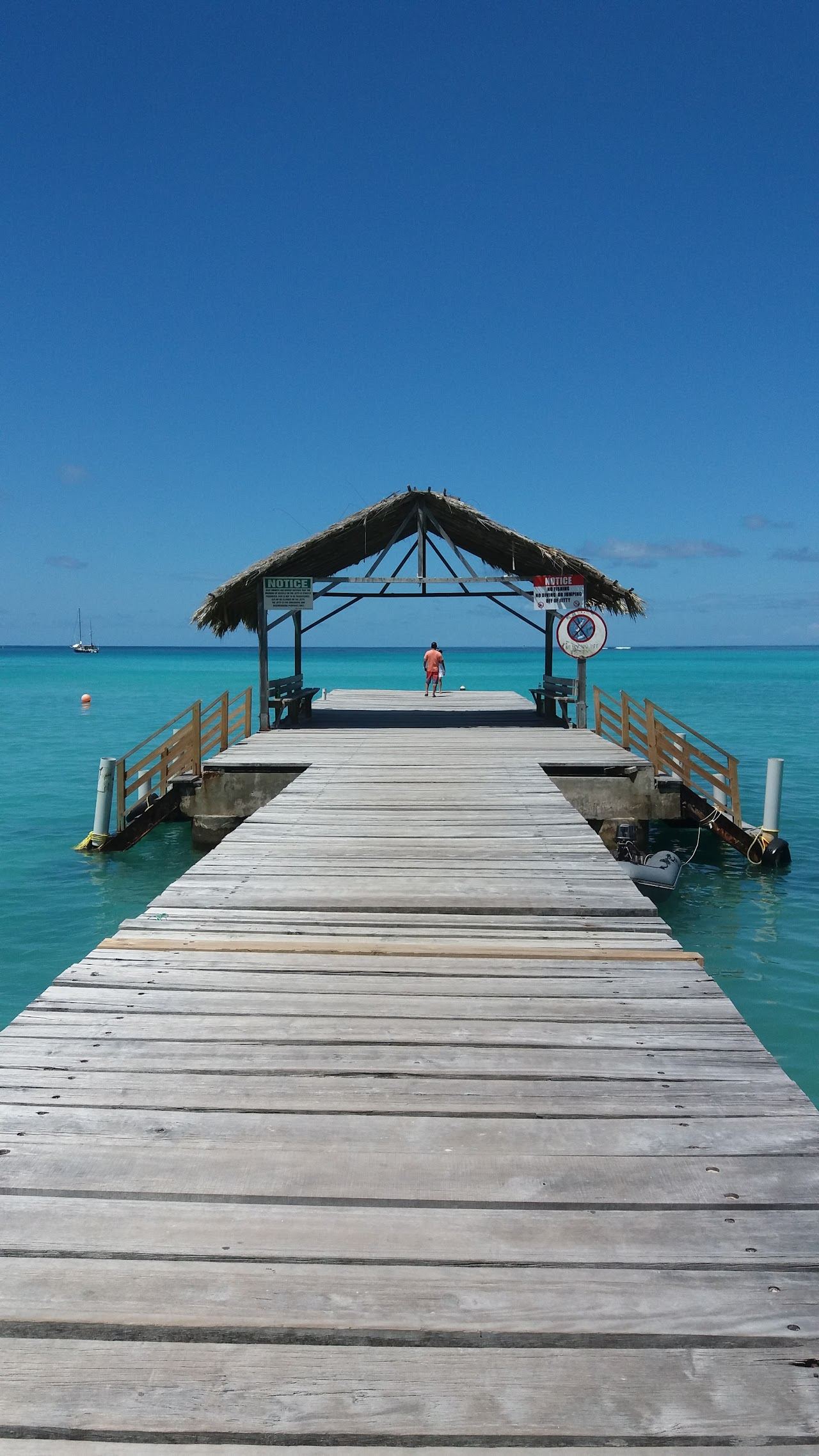 The thatched jetty and calm turquoise water at Pigeon Point in Tobago