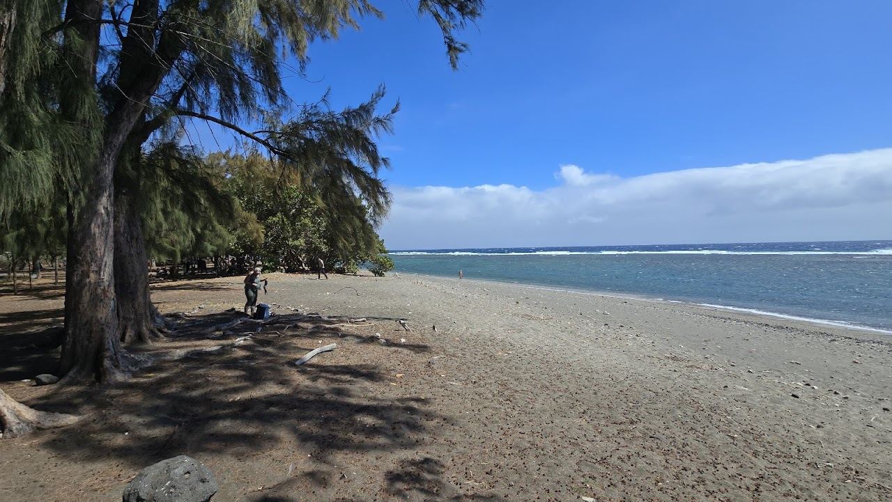 The reef lagoon and palm fringed shore at Plage de Saint Leu on the west coast of Reunion