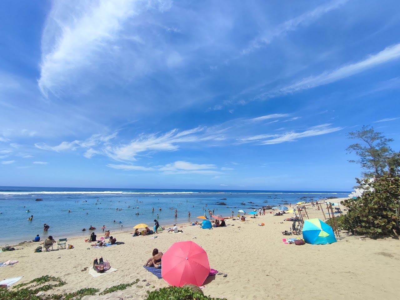 White sand and a sheltered turquoise lagoon at Plage de Saint Pierre beside the port town in southern Reunion