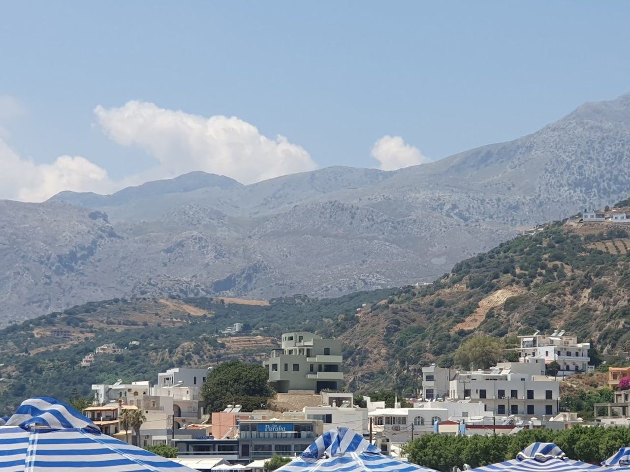 Long sandy bay and mountains behind the village of Plakias on the south coast of Crete