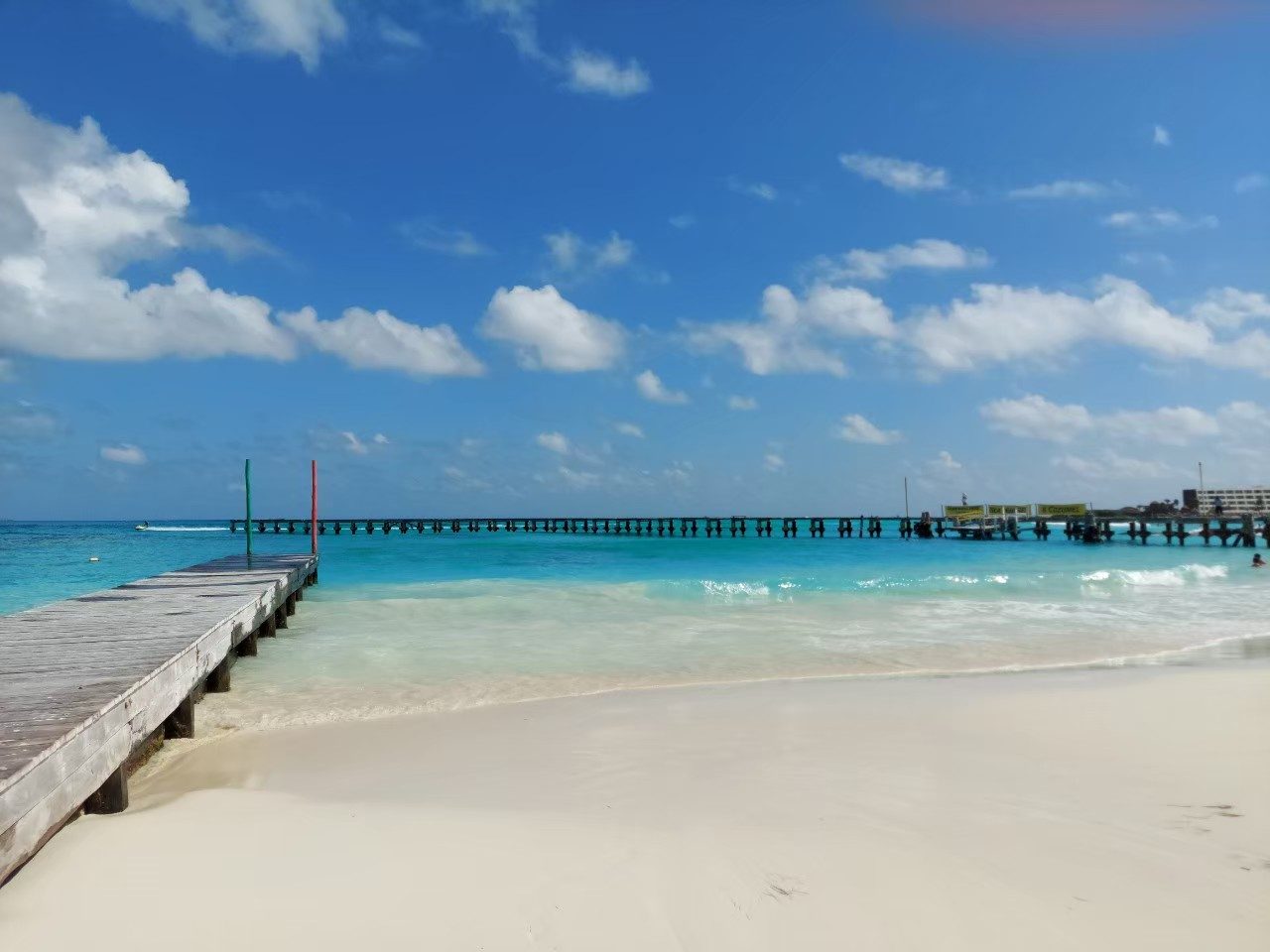 Calm clear shallow water and white sand at Playa Caracol near Punta Cancun