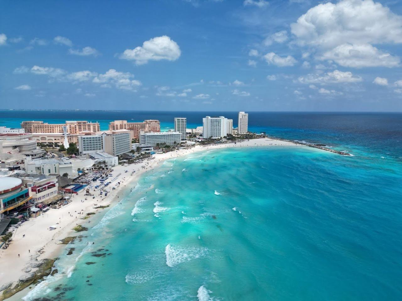 Wide white sand and moderate waves at Playa Chac Mool in central Cancun