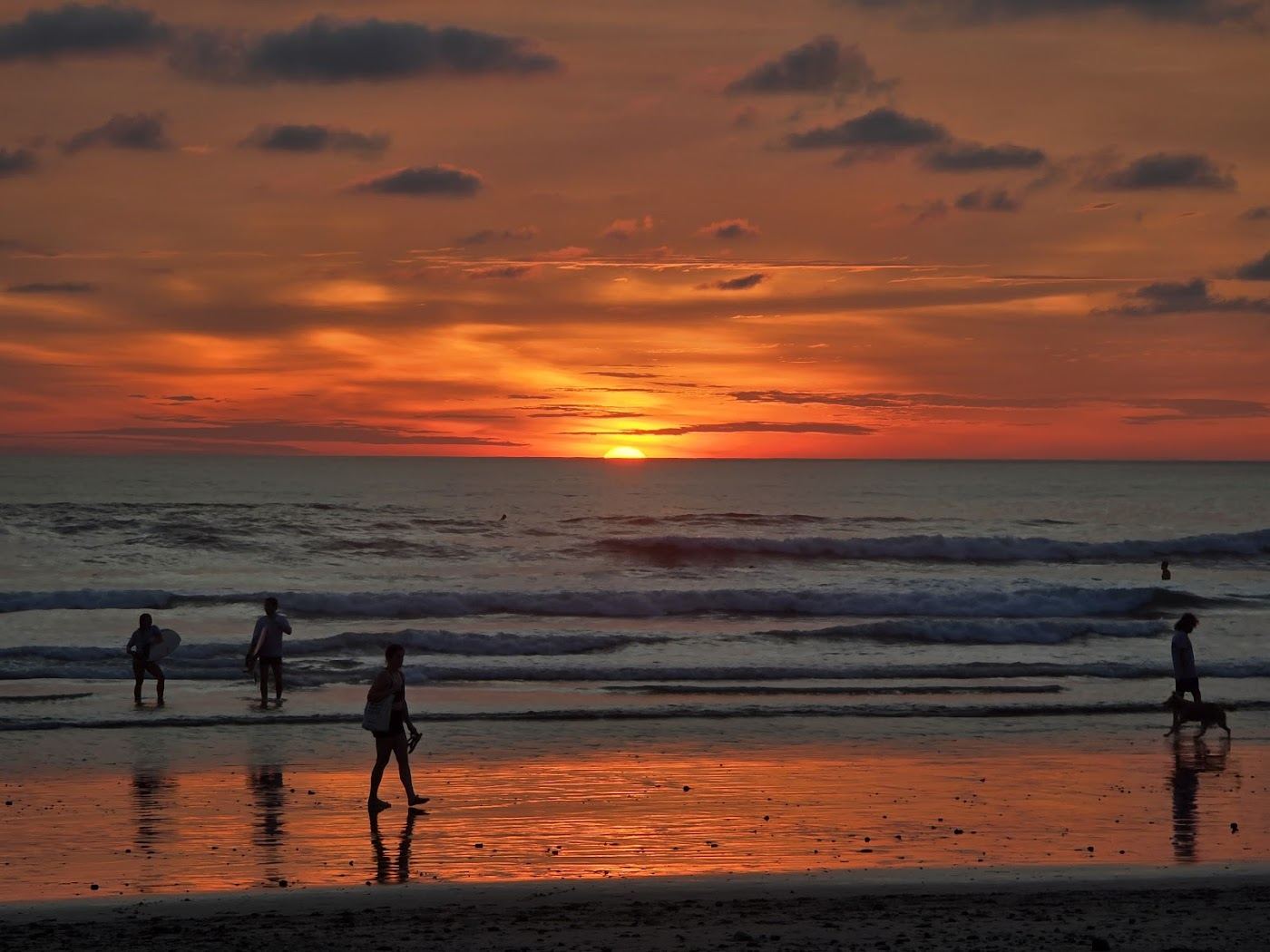 Low sun and breaking waves on the long sand of Playa Santa Teresa Costa Rica