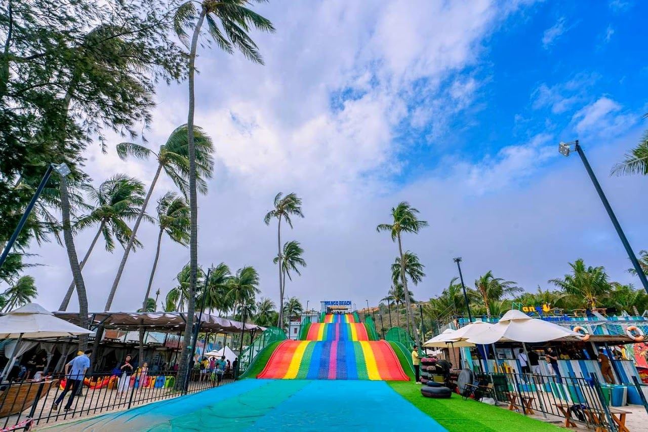 Daybeds and a wooden deck on the sand at a beach club on Mui Ne Beach