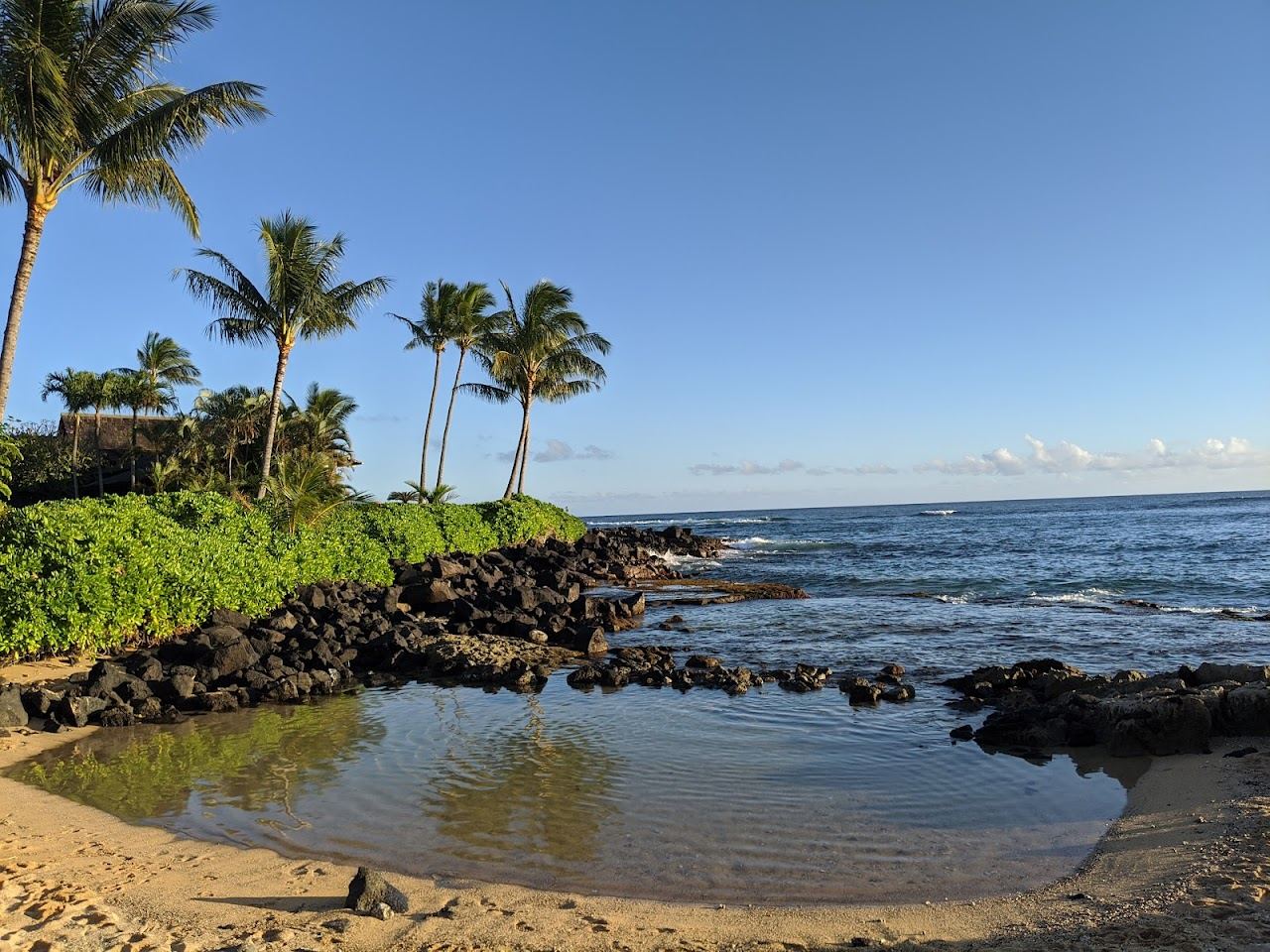 The sheltered keiki pool and sandbar point at Poipu Beach on the south shore of Kauai