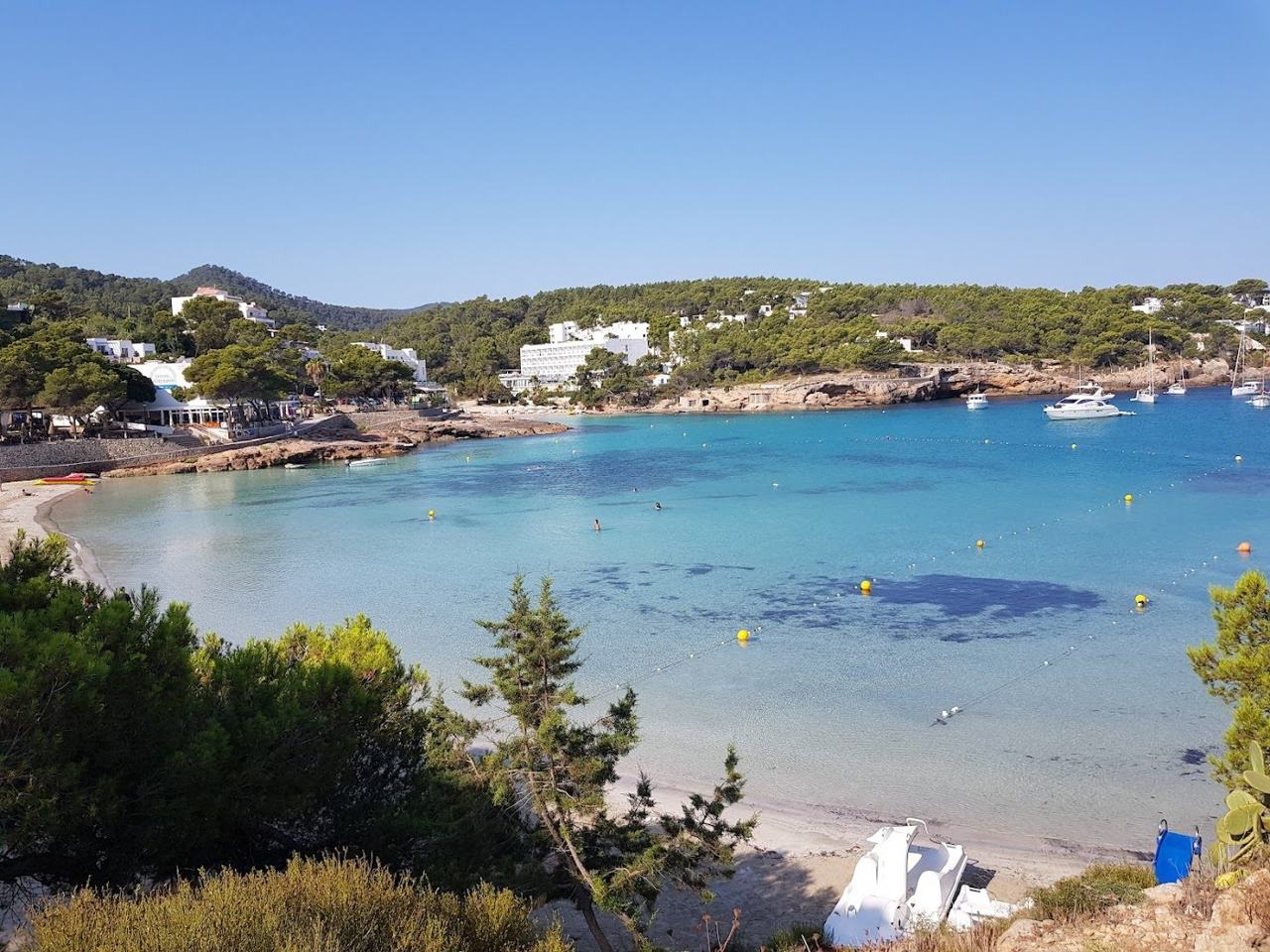 One of the sheltered sandy coves at Portinatx with clear shallow water in the far north of Ibiza