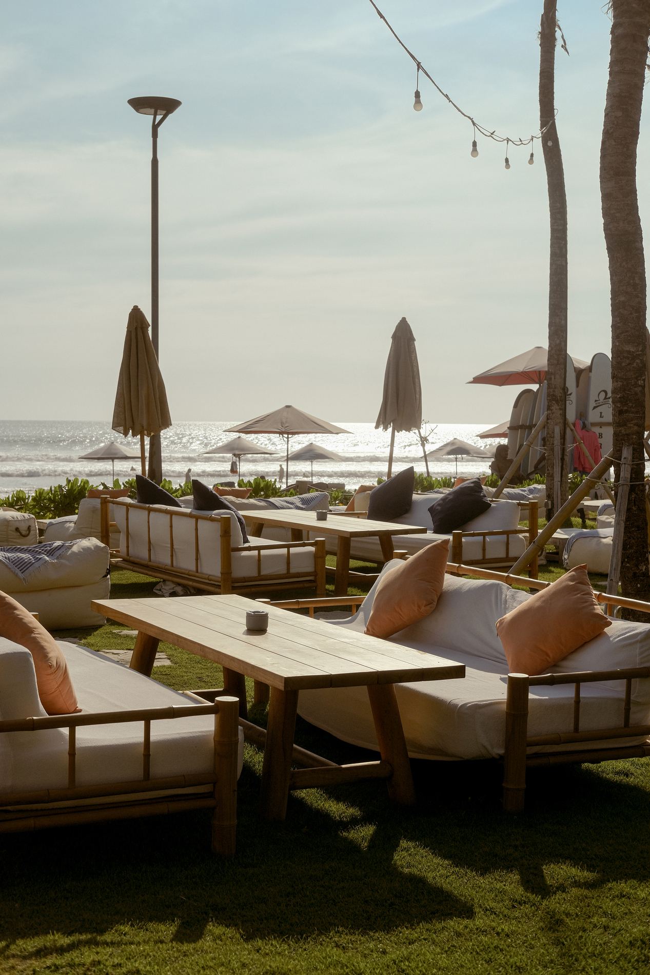 The wide grey volcanic sand and evening sky along Seminyak beach in Bali