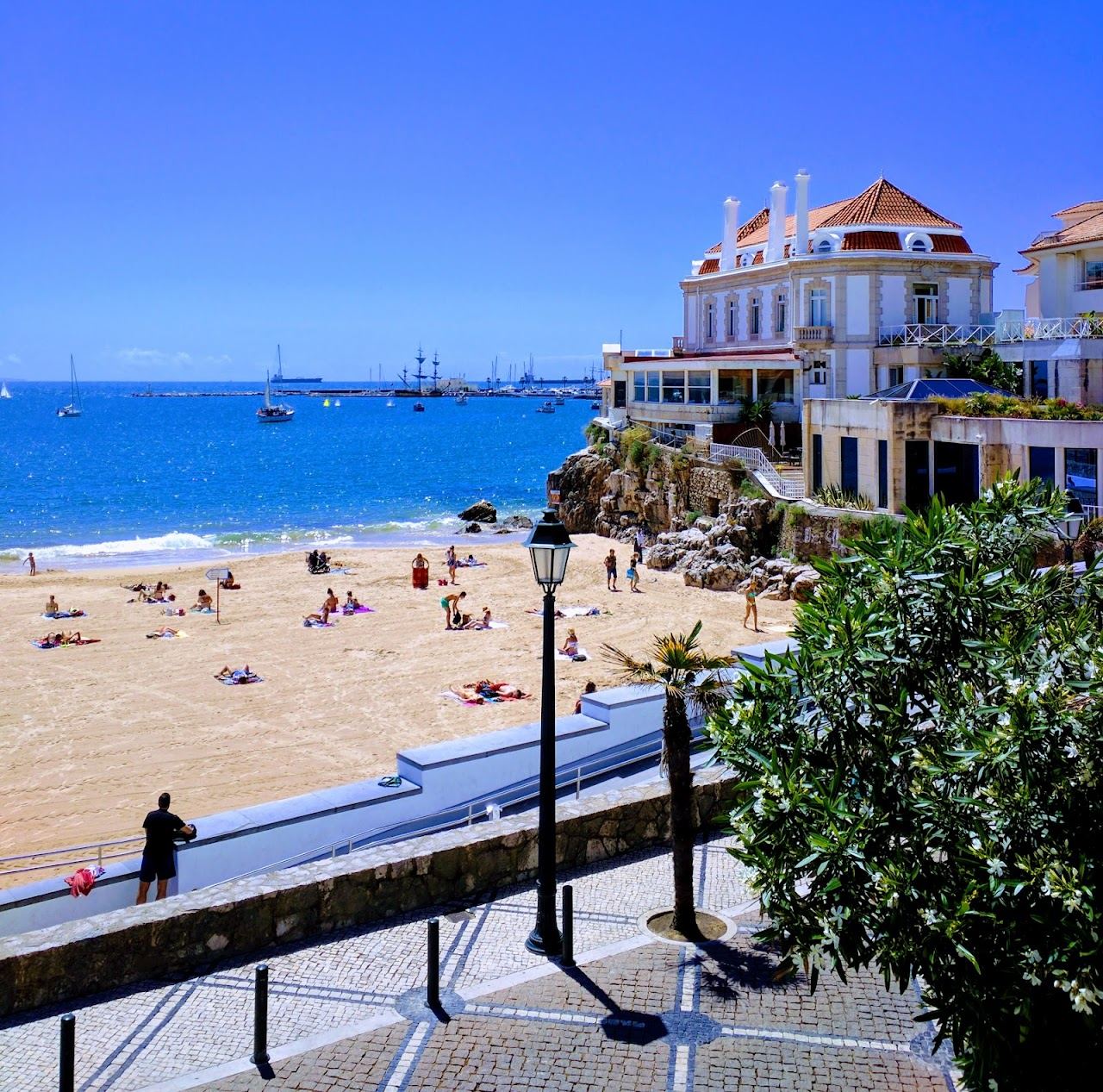 The calm golden sand and sheltered water of Praia da Conceicao in Cascais, Portugal