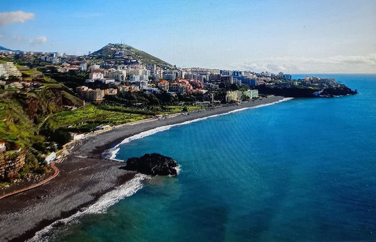 The long pebble and sand sweep of Praia Formosa in Funchal, the beach beside Doca do Cavacas