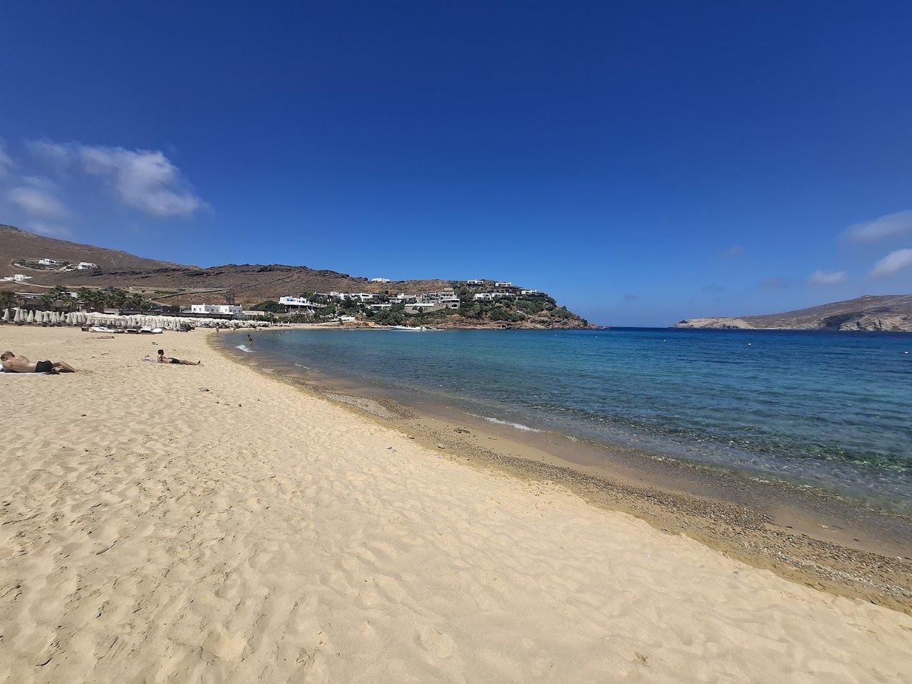 Pale sand and blue water along Panormos bay on the north coast of Mykonos