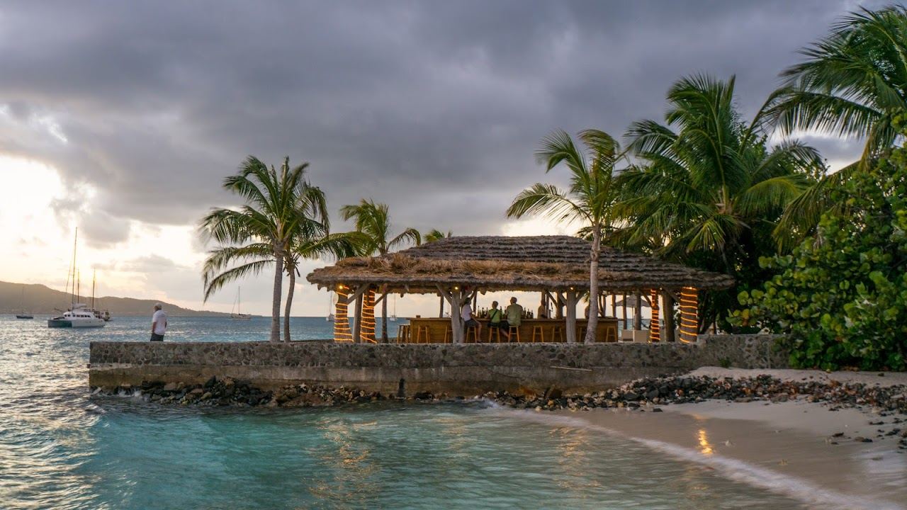 Stone cottage above a quiet beach at Petit St Vincent in the Grenadines