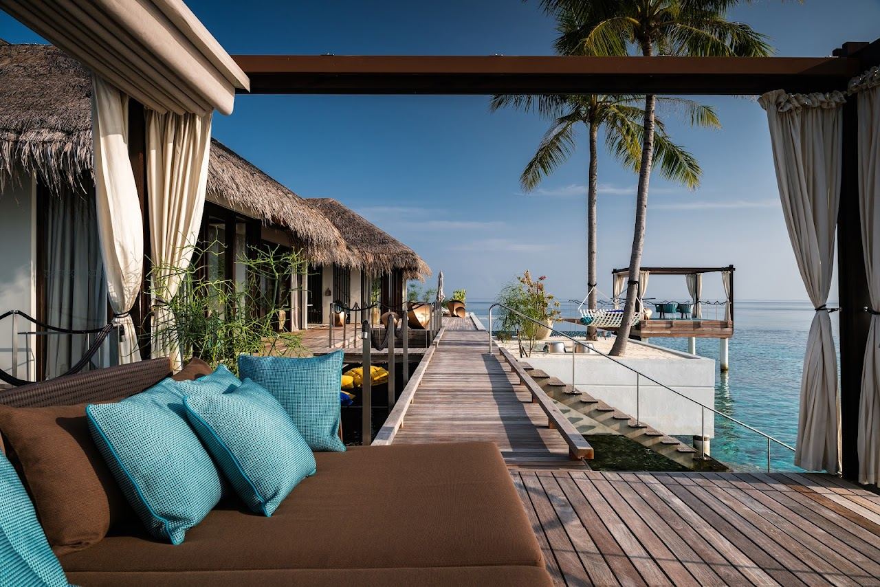 Overwater villas and clear lagoon at Velaa Private Island in the Maldives