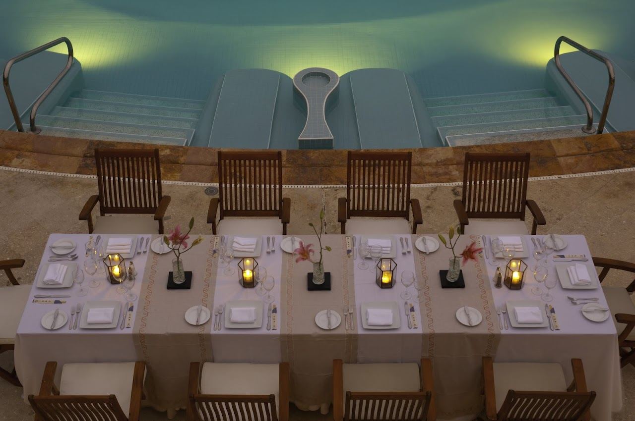 Day beds and a pool overlooking the sea at a beach club in Puerto Vallarta, Mexico