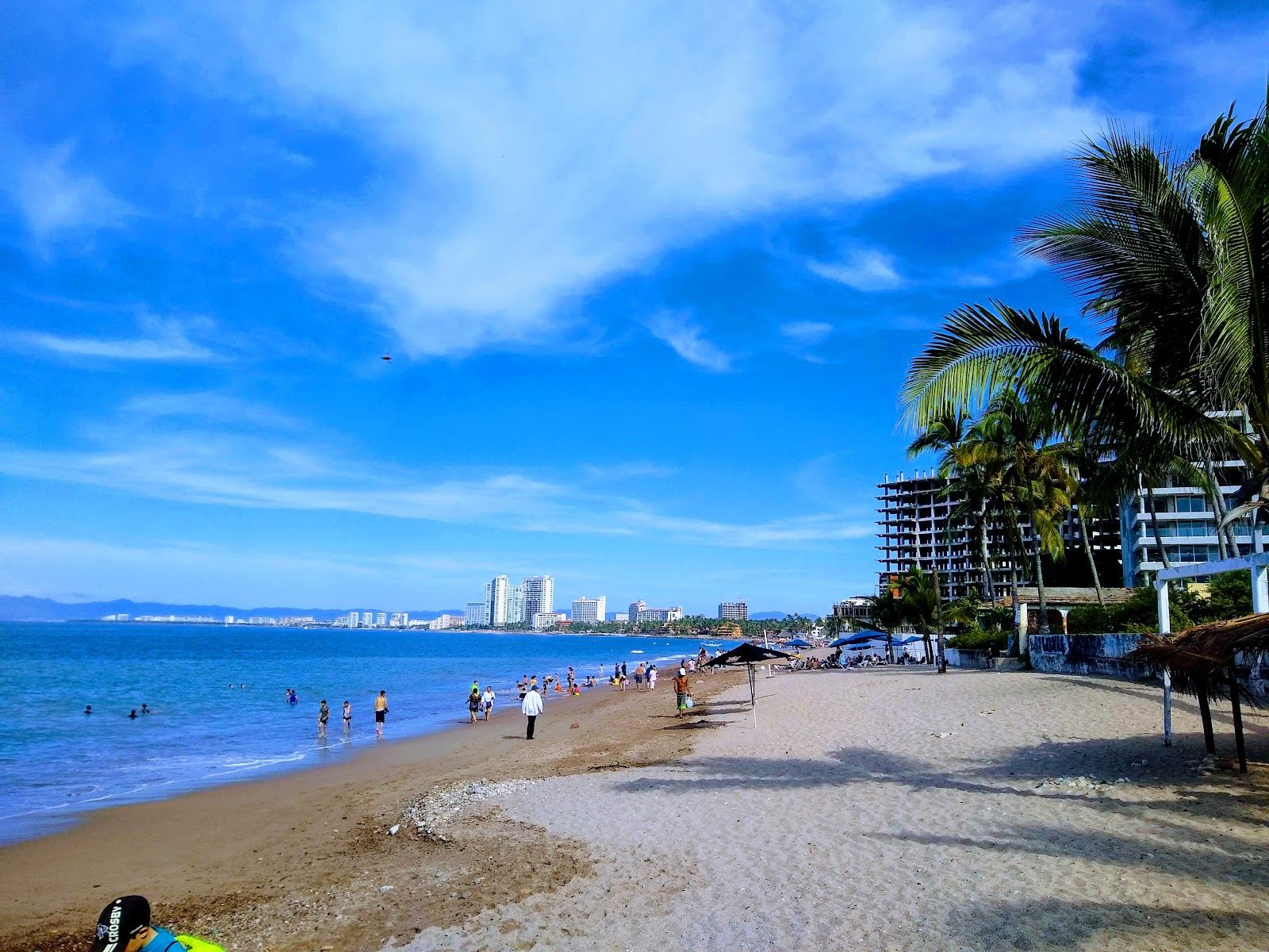 Golden evening light over the wide sand of Playa Camarones on Banderas Bay in Puerto Vallarta