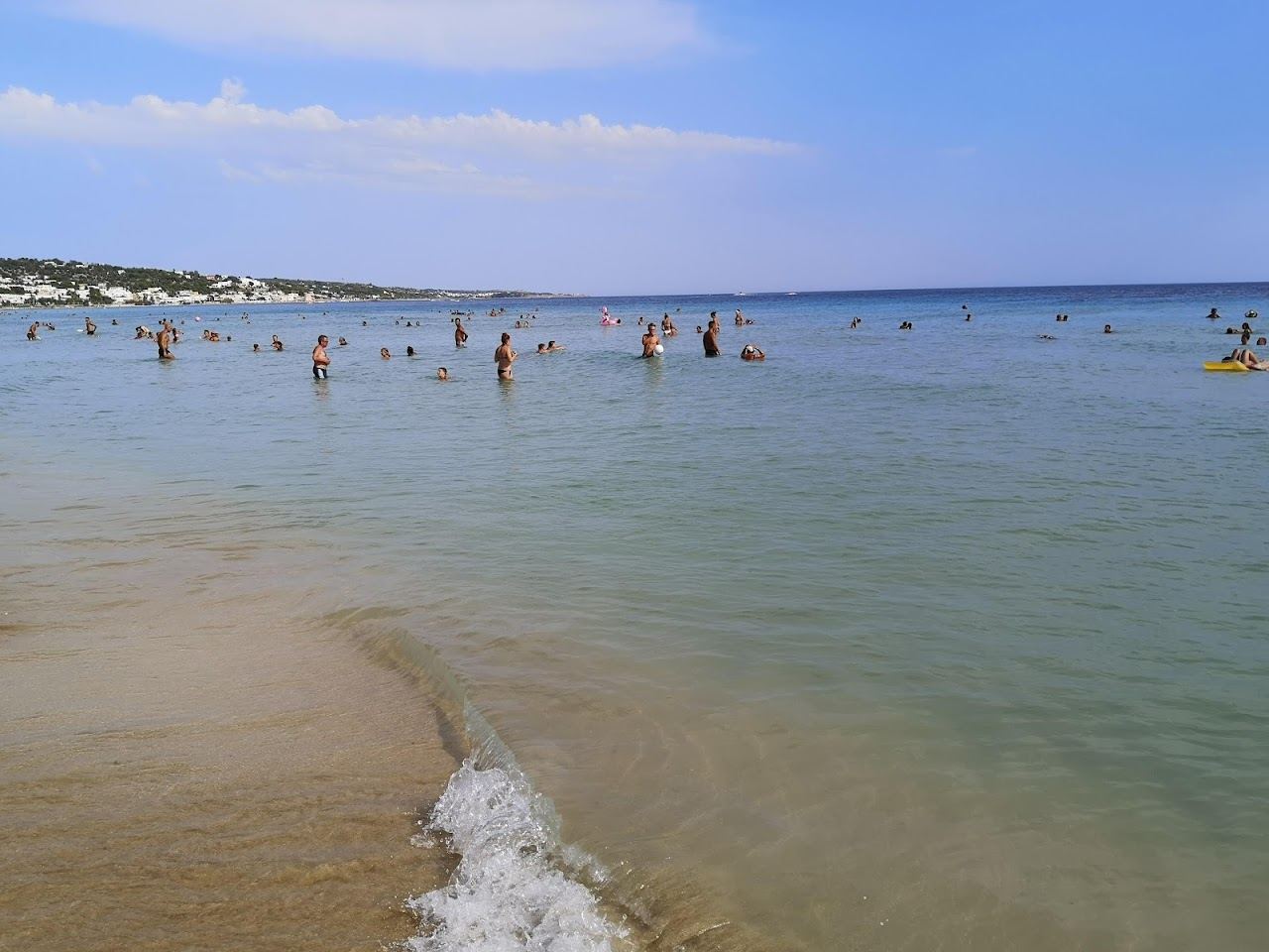 Shallow flat turquoise water over white sand at Pescoluse on the calm Ionian coast of Puglia