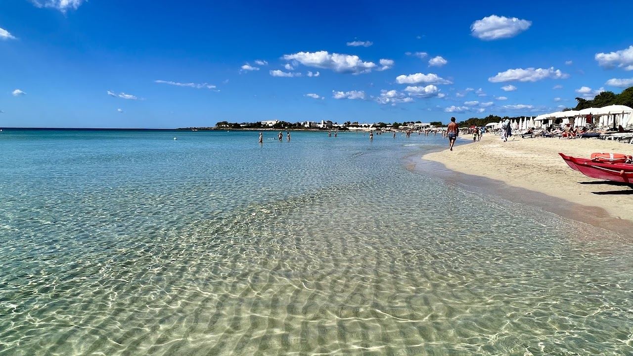 White sand, low dunes and shallow emerald water at Punta Prosciutto in the Porto Cesareo marine reserve, Puglia