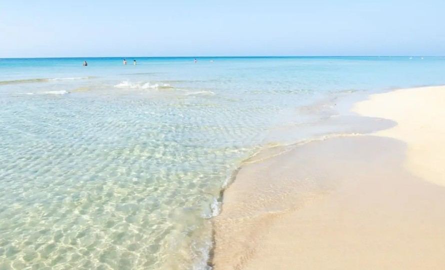 Shallow turquoise water over white sand at Marina di Pescoluse in the Salento, Puglia