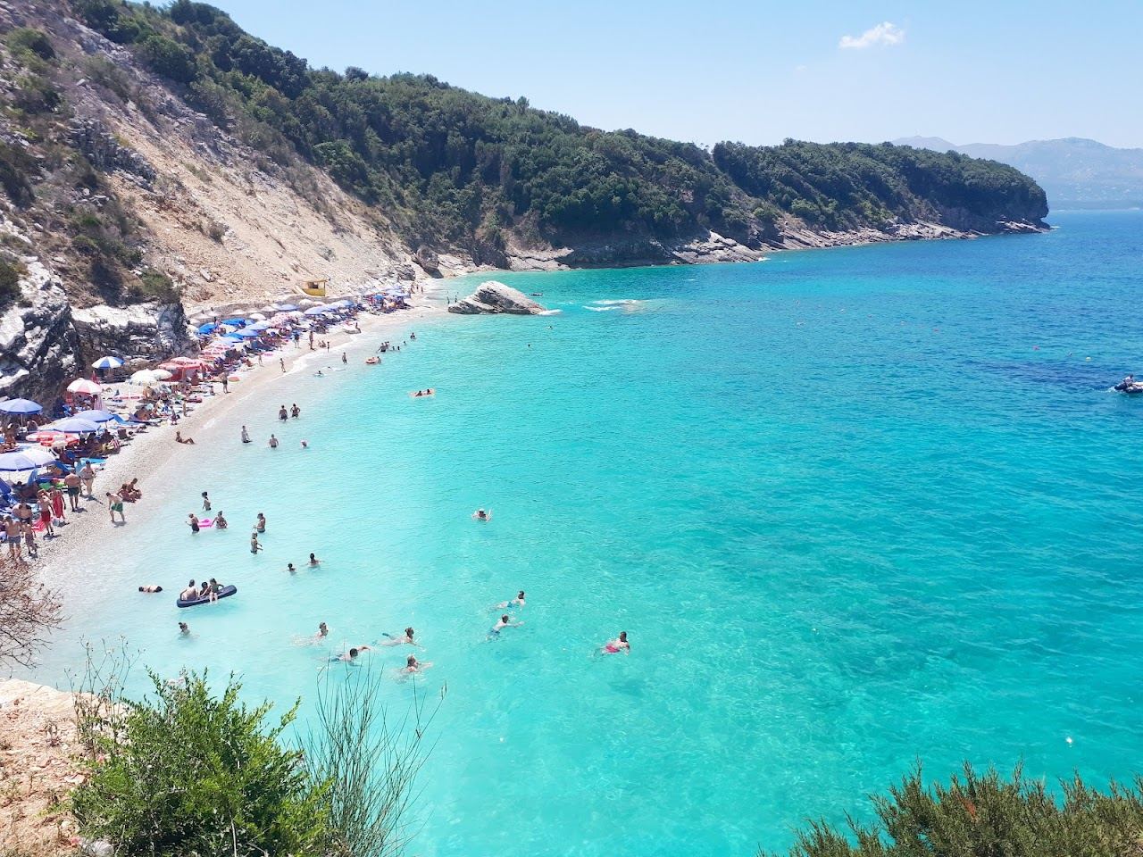 The small beach restaurants above the bright cove of Pulebardha on the Albanian Riviera