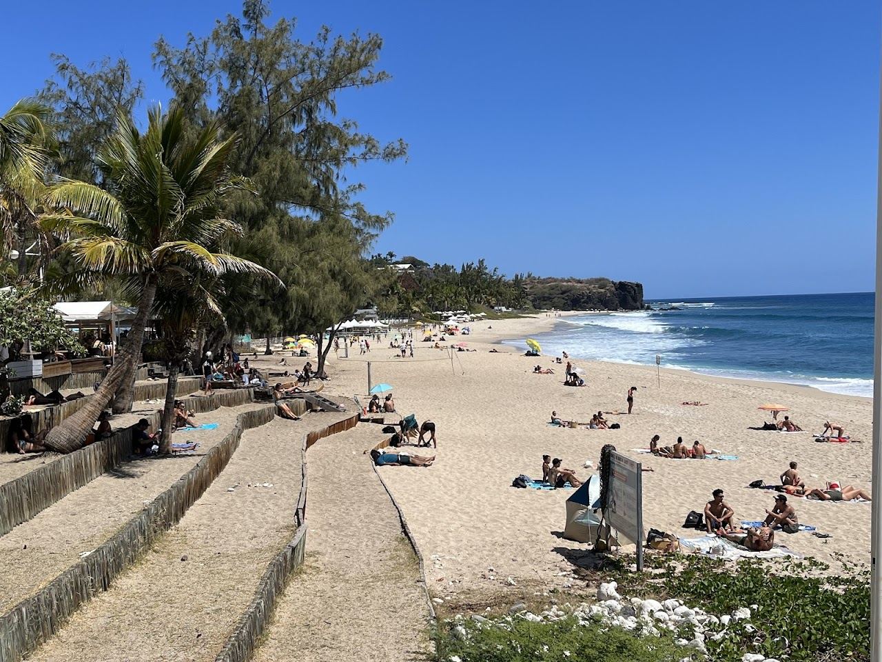 Groomed pale sand and restaurants behind the beach at Boucan Canot near Saint Gilles in Reunion