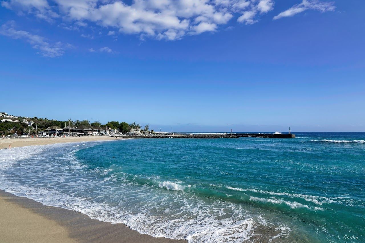 The white sand town beach and turquoise water at Roches Noires in Saint Gilles les Bains, Reunion