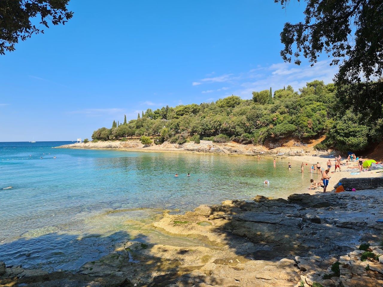 Pebble bay and clear water at Saccorgiana beach on the Verudela peninsula near Pula