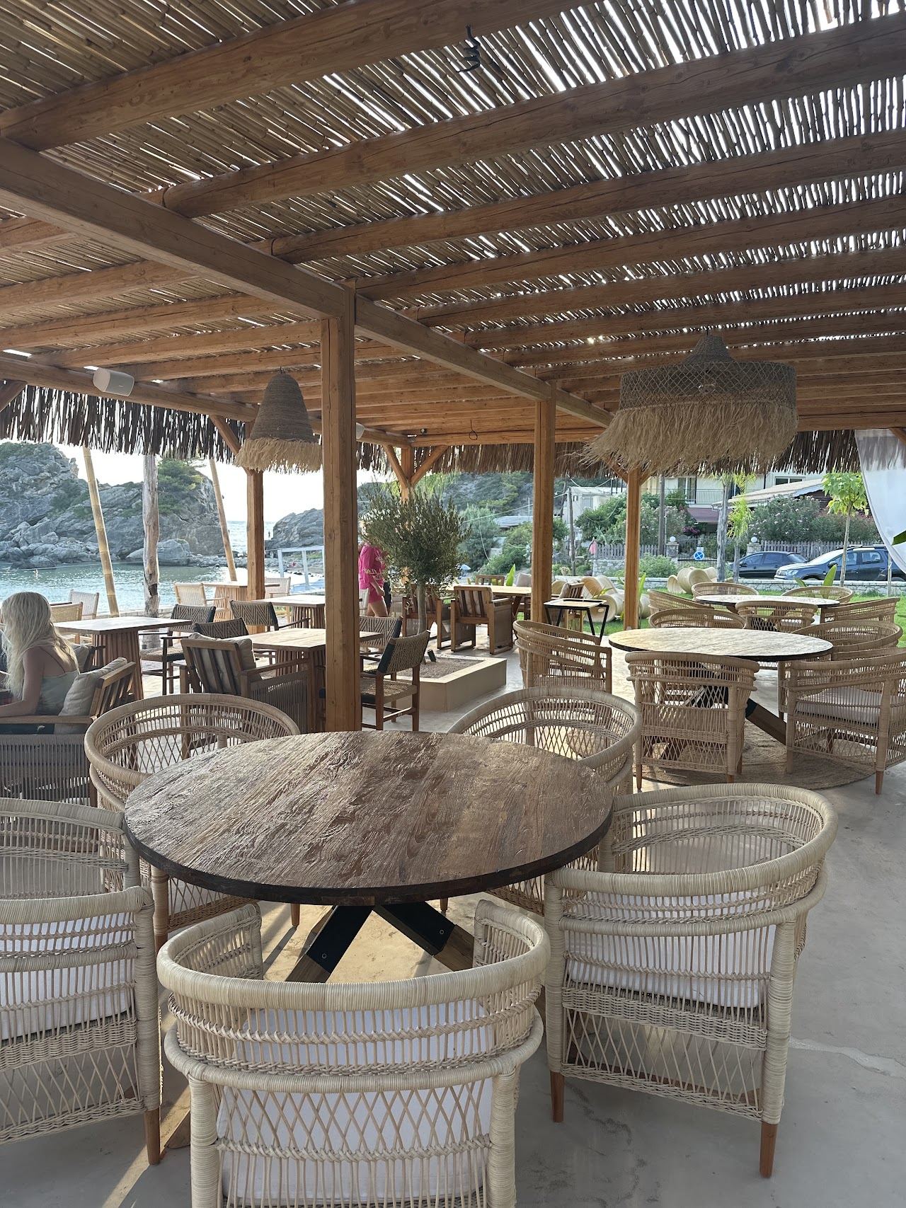 Padded sunbeds and umbrellas on the golden sand in front of Sakhar beach bar on Kontogialos, Corfu