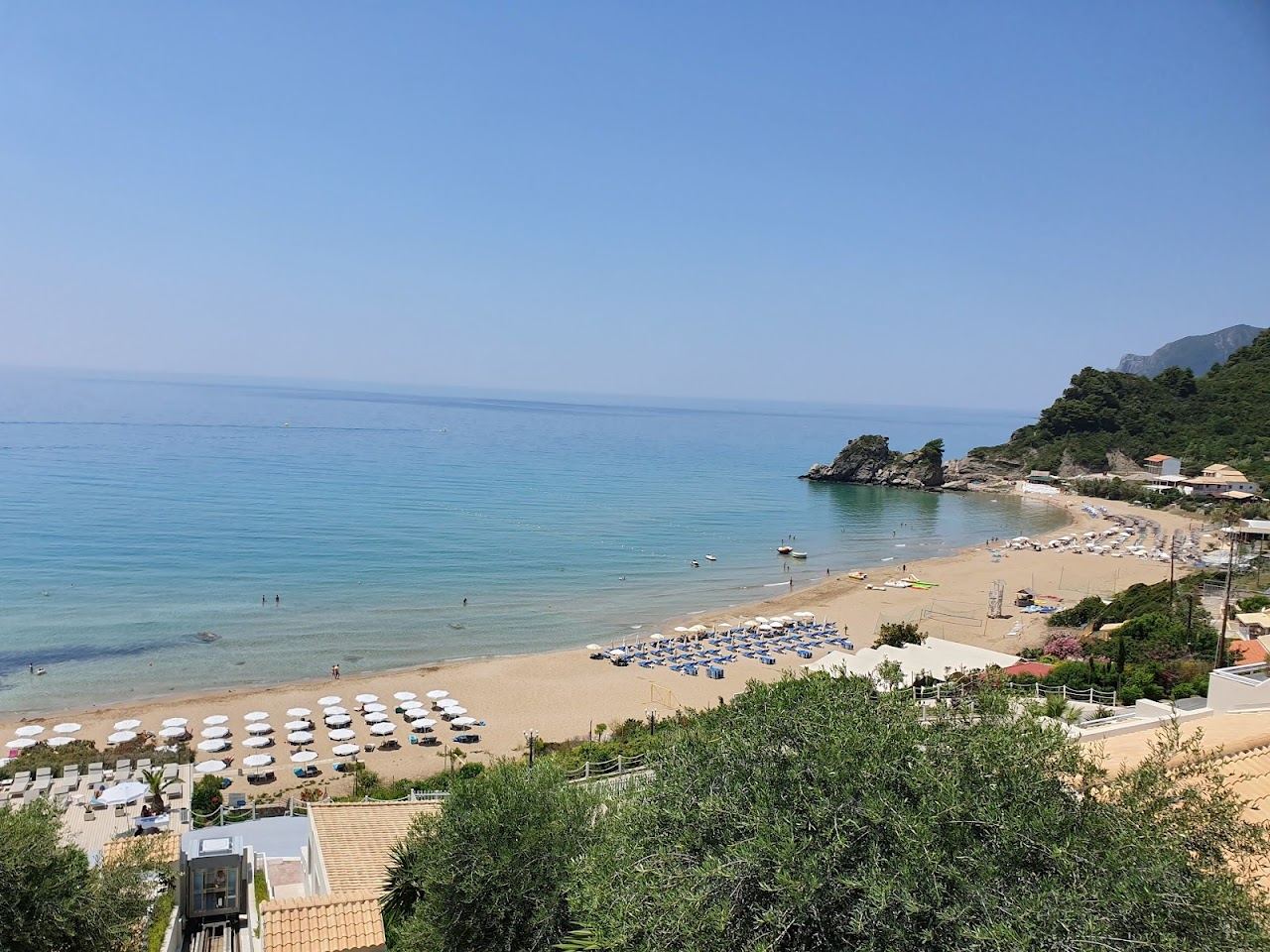 Golden sand and calm clear water at Kontogialos beach seen from the hillside above