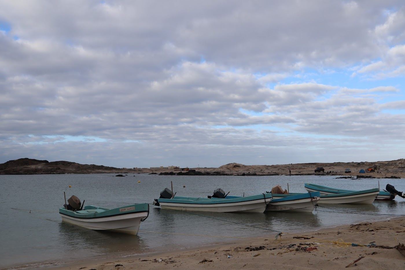The quiet sand and clear water at Mirbat Beach near Salalah