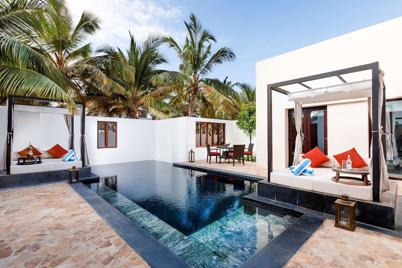 Private white sand beach and cabanas at a resort front near Salalah in Oman