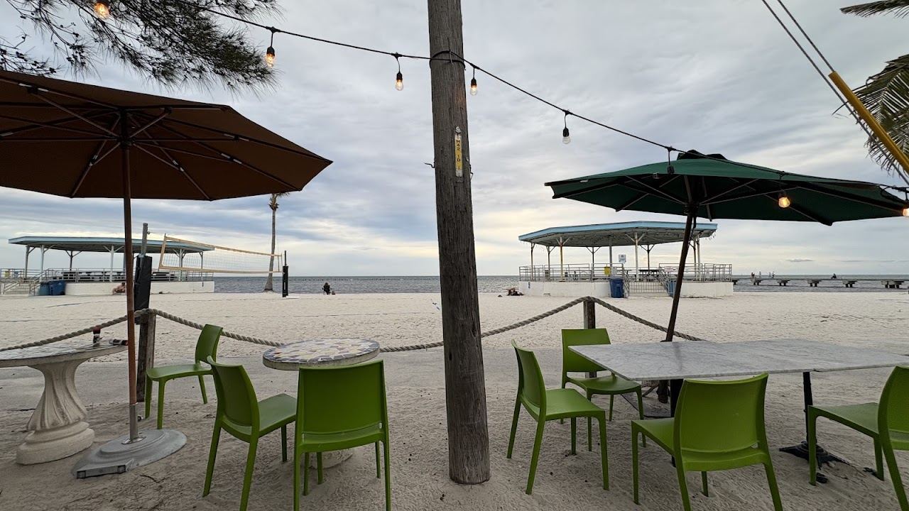 Diners at the open air tables of Salute! On The Beach beside the sand