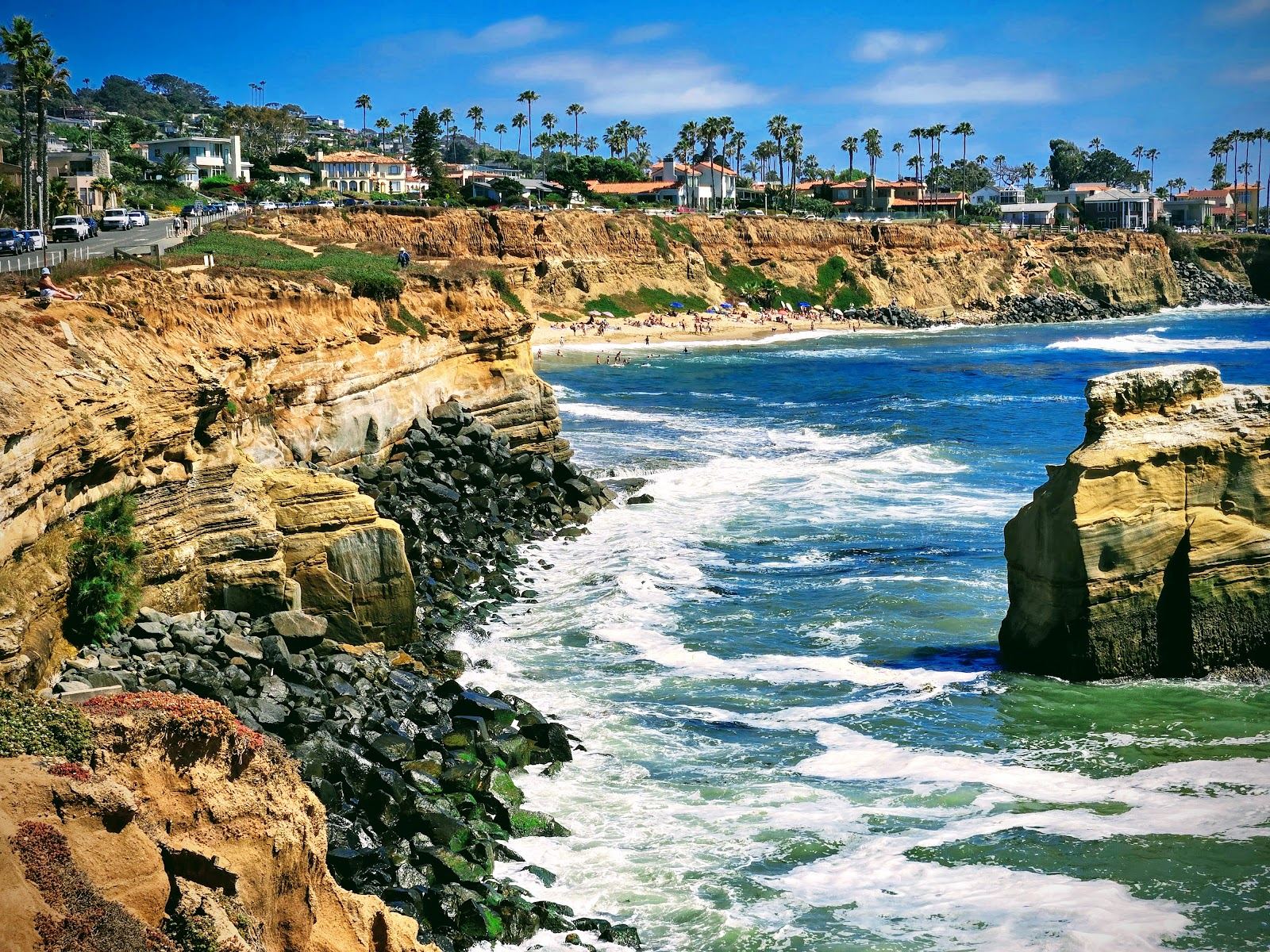 The sandstone bluffs of Sunset Cliffs Natural Park in San Diego glowing above the Pacific as the sun drops to the horizon