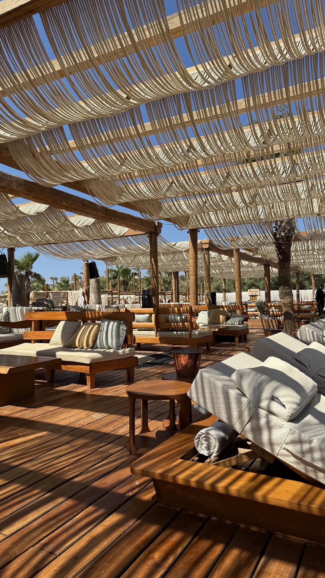 Loungers and cabanas around the large saltwater pool at SantAnna Mykonos on Paraga beach
