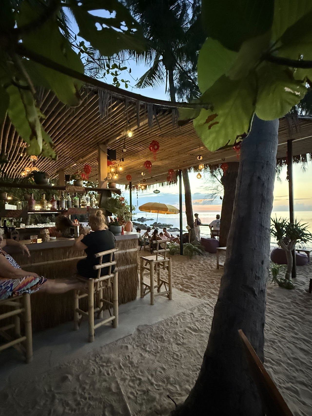 Lounge chairs and umbrellas of the beach bar on the Secret Beach cove at Haad Son, Koh Phangan