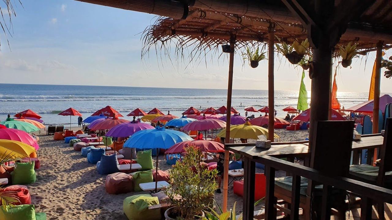 Colourful umbrellas and beanbags on the sand at La Plancha in Seminyak