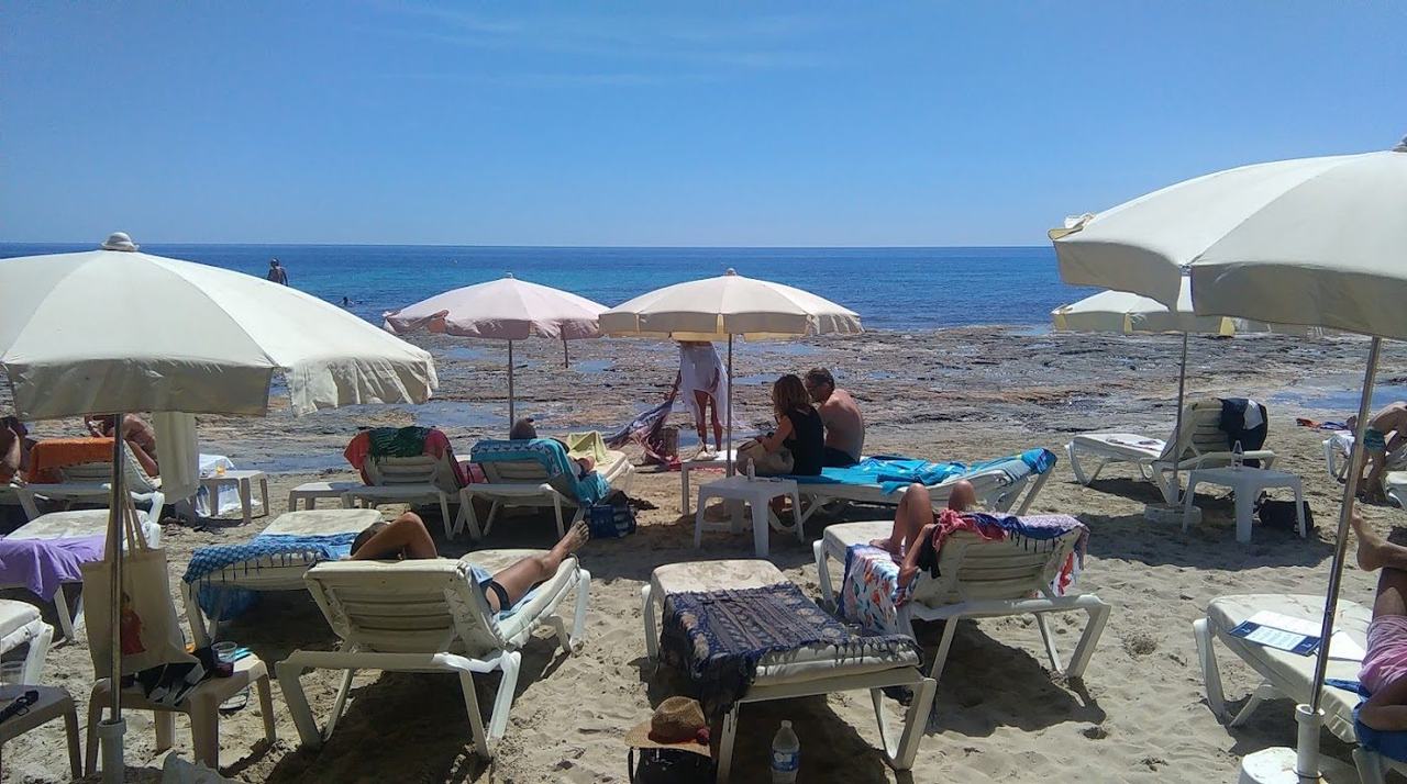 Sunbeds and beach bars along the protected strip of Ses Salines Beach in the Ibiza salt park