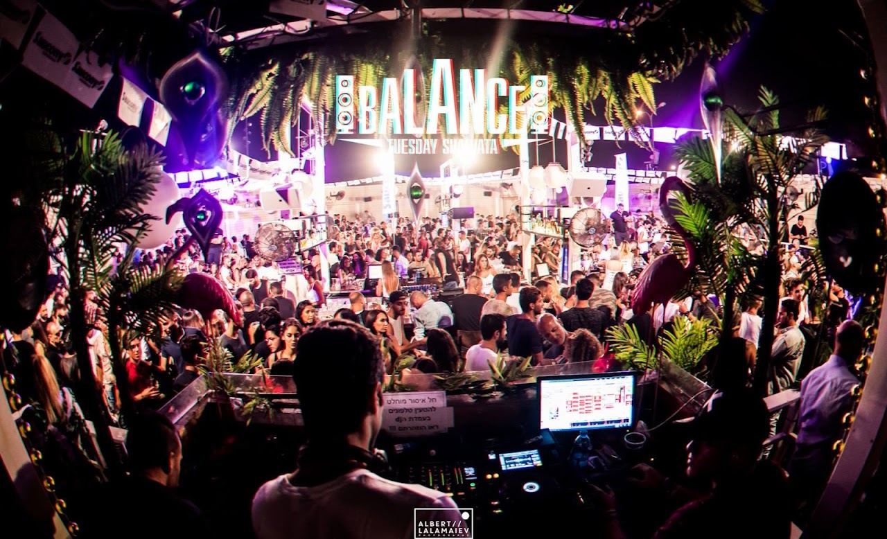 Crowd and lit deck at Shalvata, the open air club on the water at the Tel Aviv port after dark