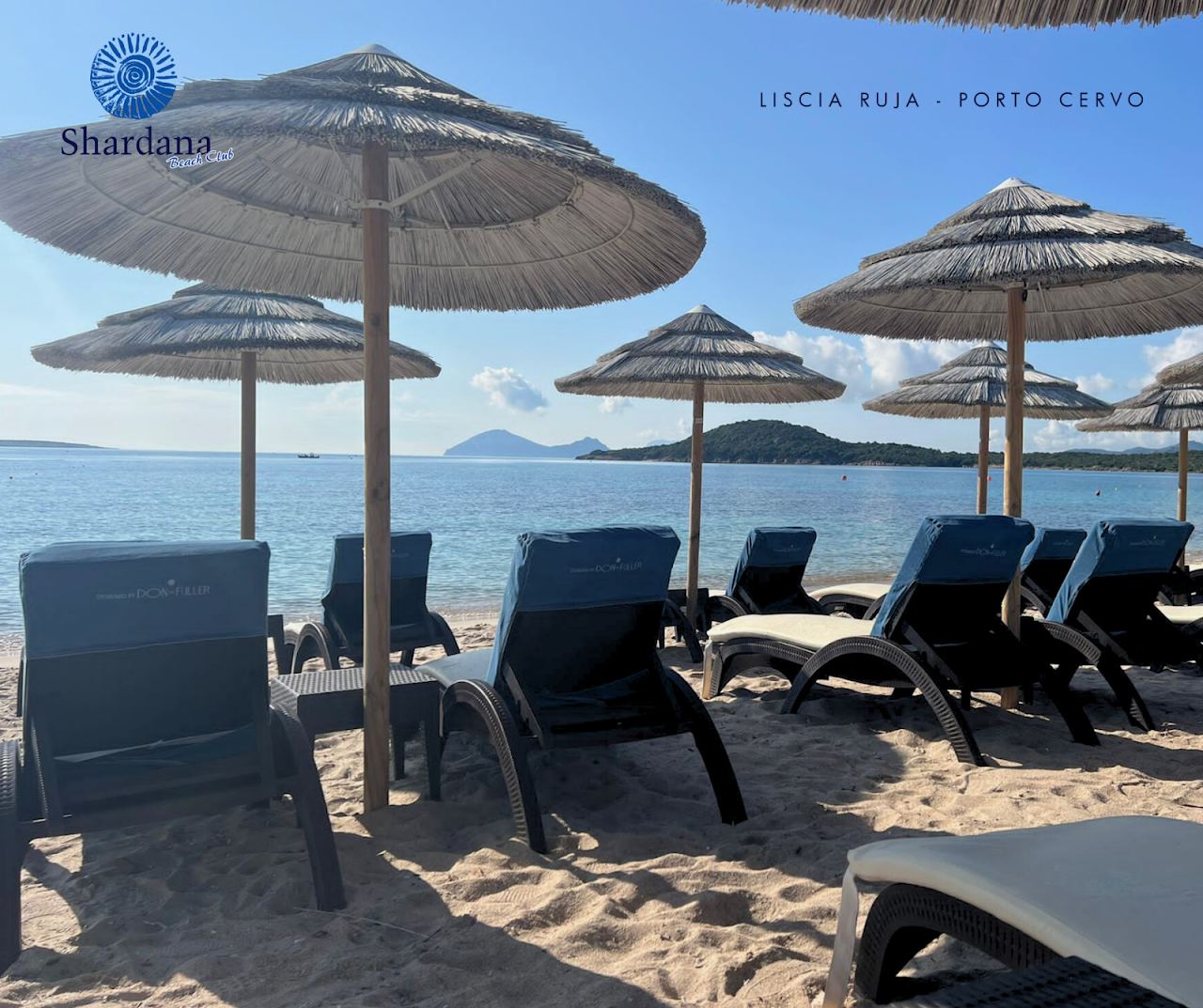 Sunbeds and umbrellas on the pale sand in front of Shardana Beach Club on Liscia Ruja, Sardinia