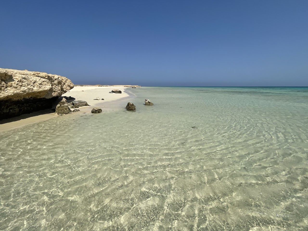 The white sand crescent and clear turquoise lagoon of Sharm El Luli south of Marsa Alam on the Red Sea in Egypt