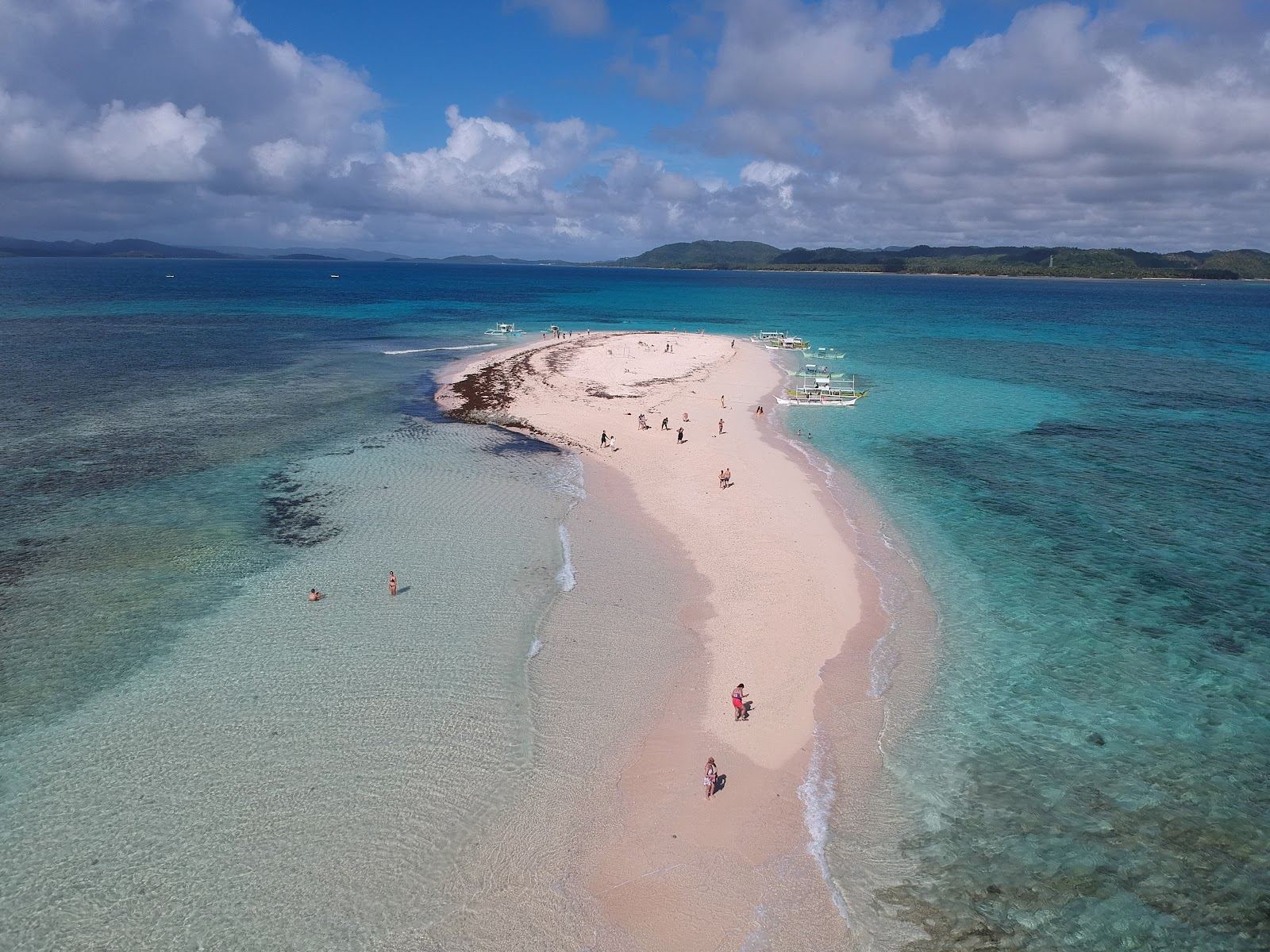 Pure white sandbar and turquoise shallows at Naked Island on the Siargao island hopping route
