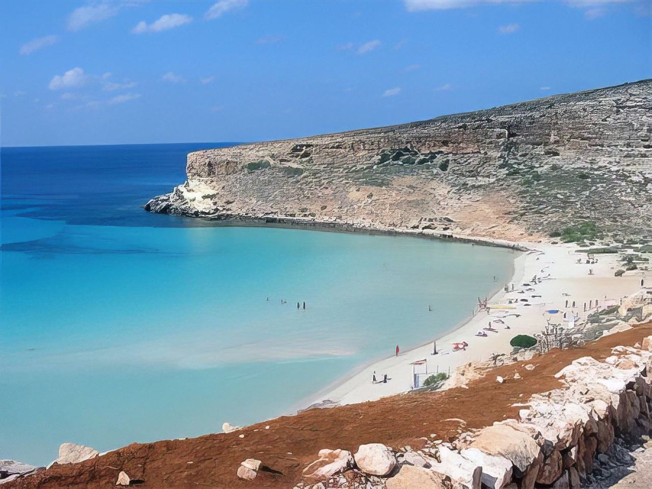 A quiet protected sandy cove backed by scrub on the southeast coast of Sicily