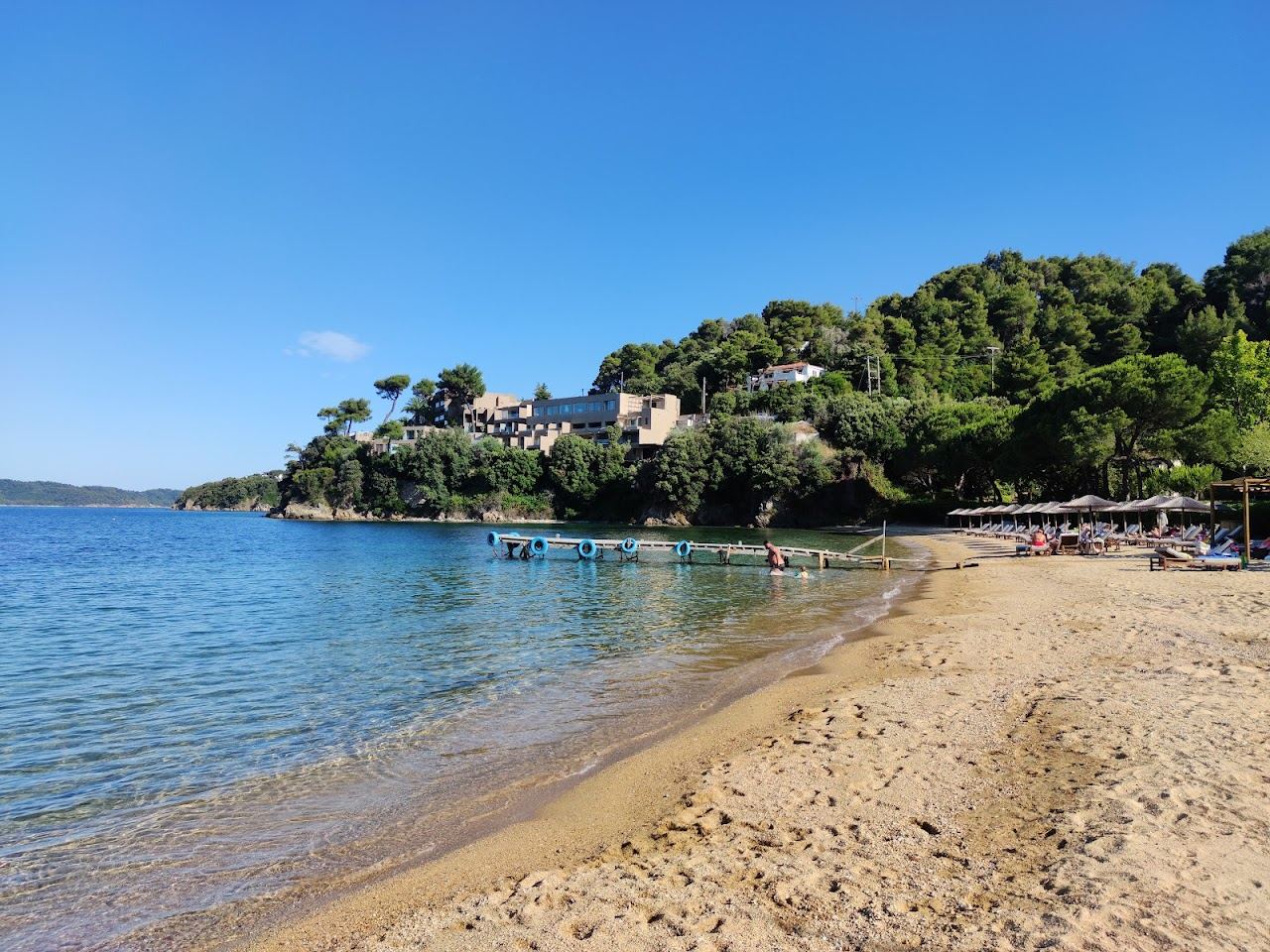 Clear turquoise water over rocks at Tzaneria beach on Skiathos in Greece