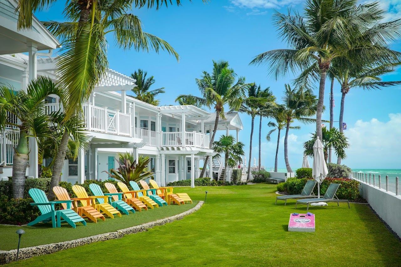 Palms and loungers along the oceanfront at the resort behind Southernmost Beach Cafe